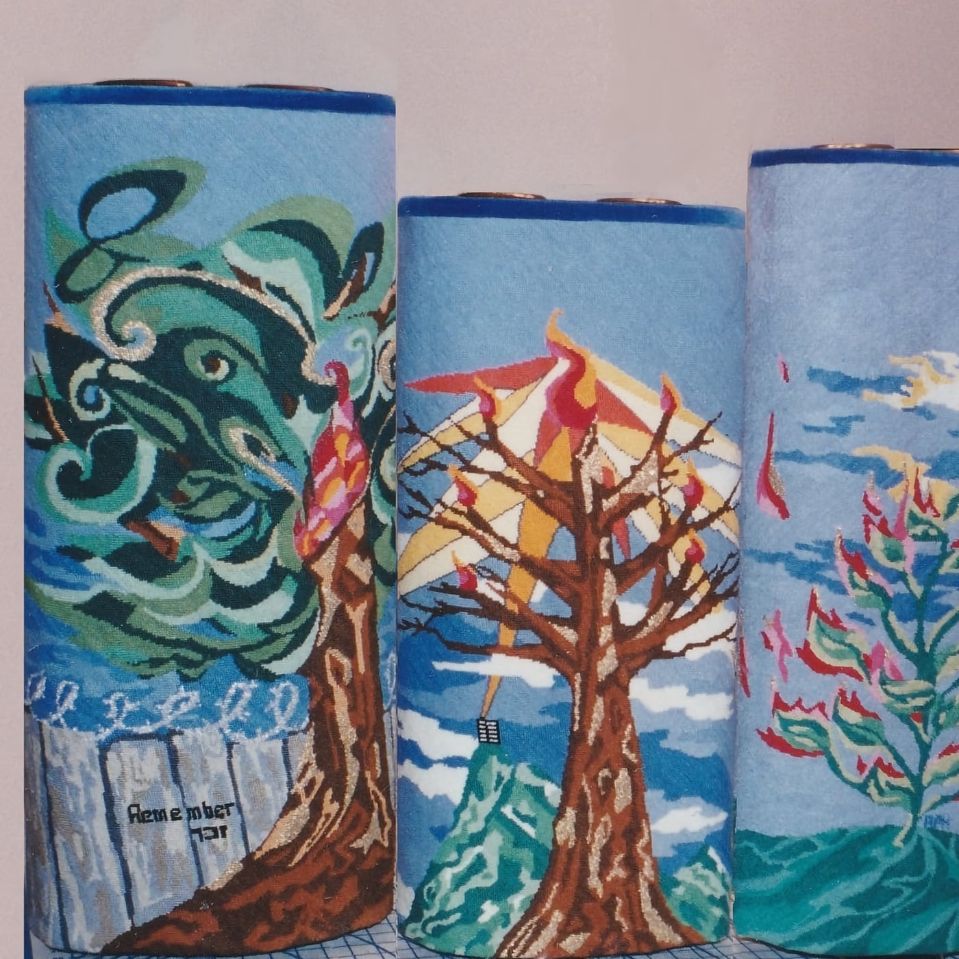 A set of four needlepoint torah covers, with nature scenes
