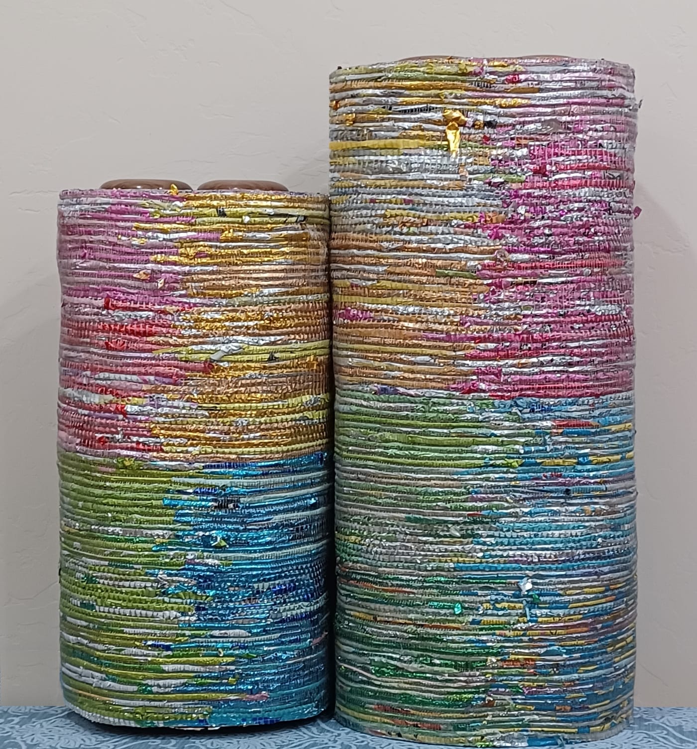 a set of colorful, woven mylar torah covers
