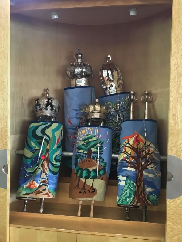 A set of needlepoint torah covers, with nature scenes