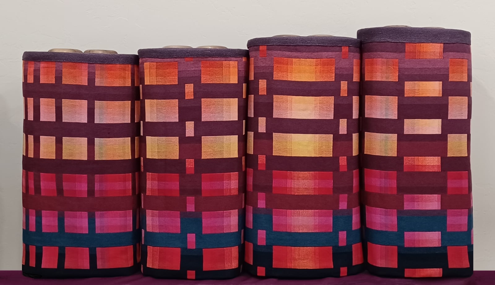 A set of hand-woven torah cover with warm colors